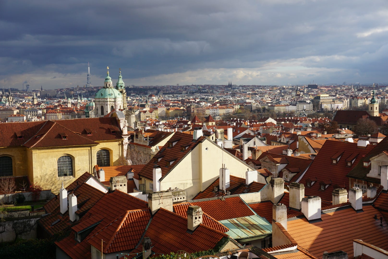 Beautiful skyline of Prague filled with red tiled roofs.